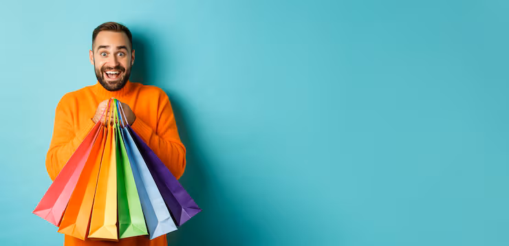 excited-adult-man-holding-shopping-bags-smiling-going-mall-standing-turquoise-background_1258-158042